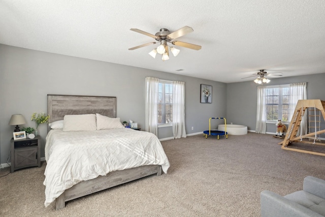 carpeted bedroom with multiple windows, ceiling fan, and a textured ceiling