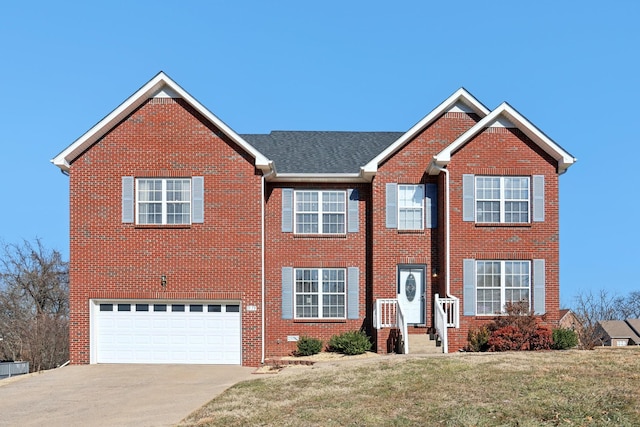 view of front of property with a garage and a front yard