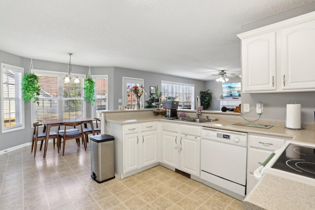 kitchen with sink, white cabinets, hanging light fixtures, kitchen peninsula, and white appliances