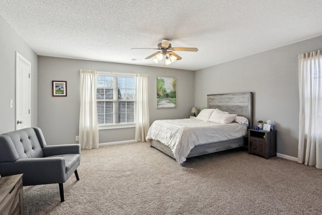 carpeted bedroom with ceiling fan and a textured ceiling