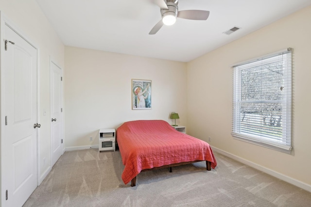 bedroom featuring ceiling fan and light colored carpet