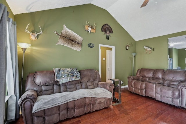 living room with ceiling fan, lofted ceiling, and dark hardwood / wood-style flooring