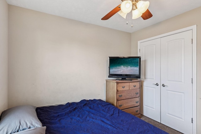 bedroom with ceiling fan and a closet