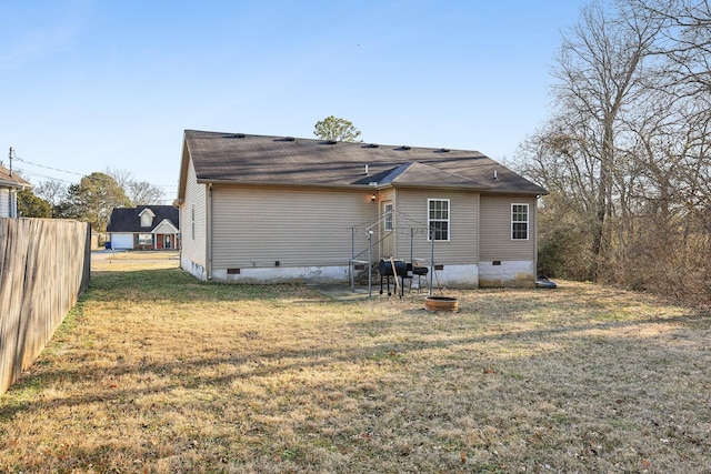 rear view of house with a yard