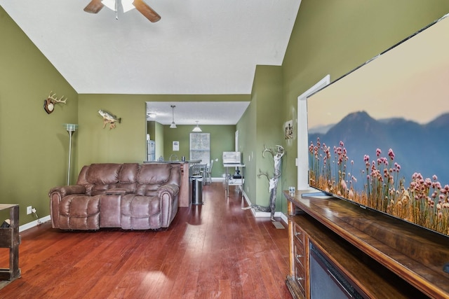 living room with vaulted ceiling, dark hardwood / wood-style floors, and ceiling fan