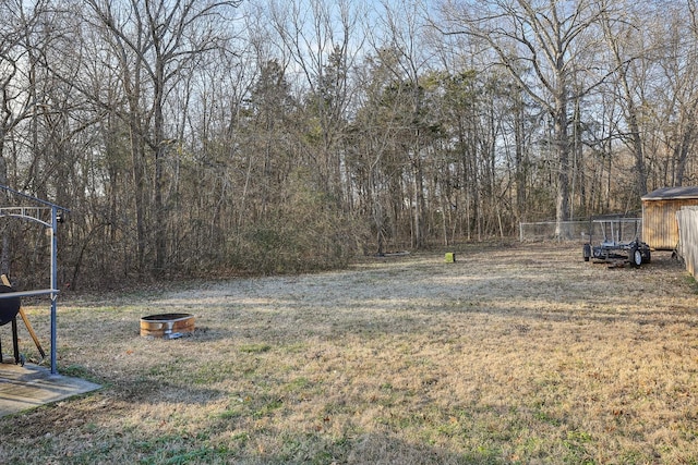 view of yard with an outdoor fire pit