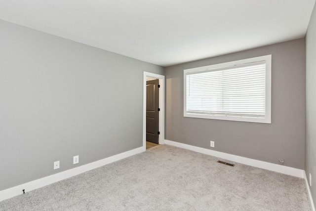 unfurnished room with light colored carpet