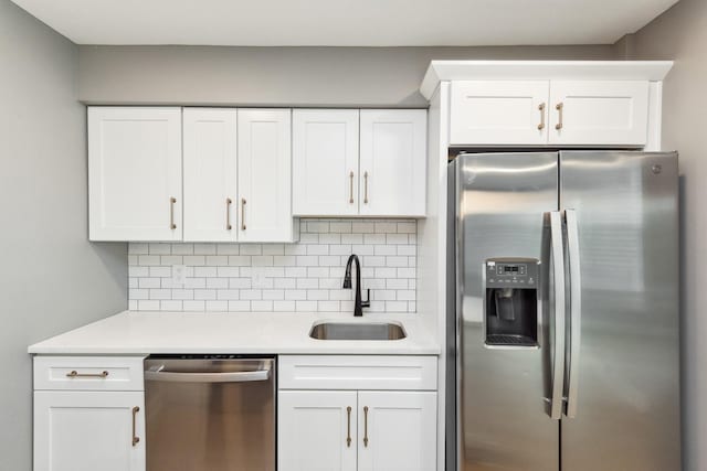 kitchen featuring stainless steel appliances, white cabinetry, and sink