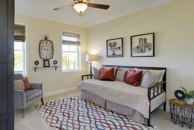 carpeted bedroom with ornamental molding and ceiling fan