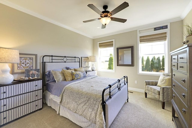 bedroom with ornamental molding, light colored carpet, and ceiling fan