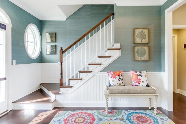 entryway with ornamental molding and dark hardwood / wood-style flooring