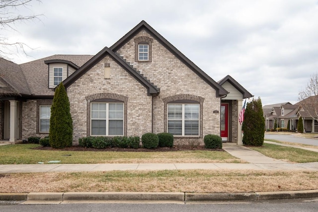 french provincial home with a front lawn