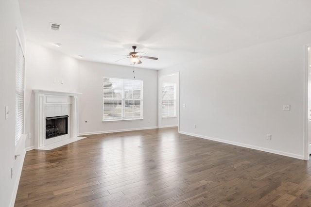 unfurnished living room with ceiling fan, dark hardwood / wood-style floors, and a high end fireplace