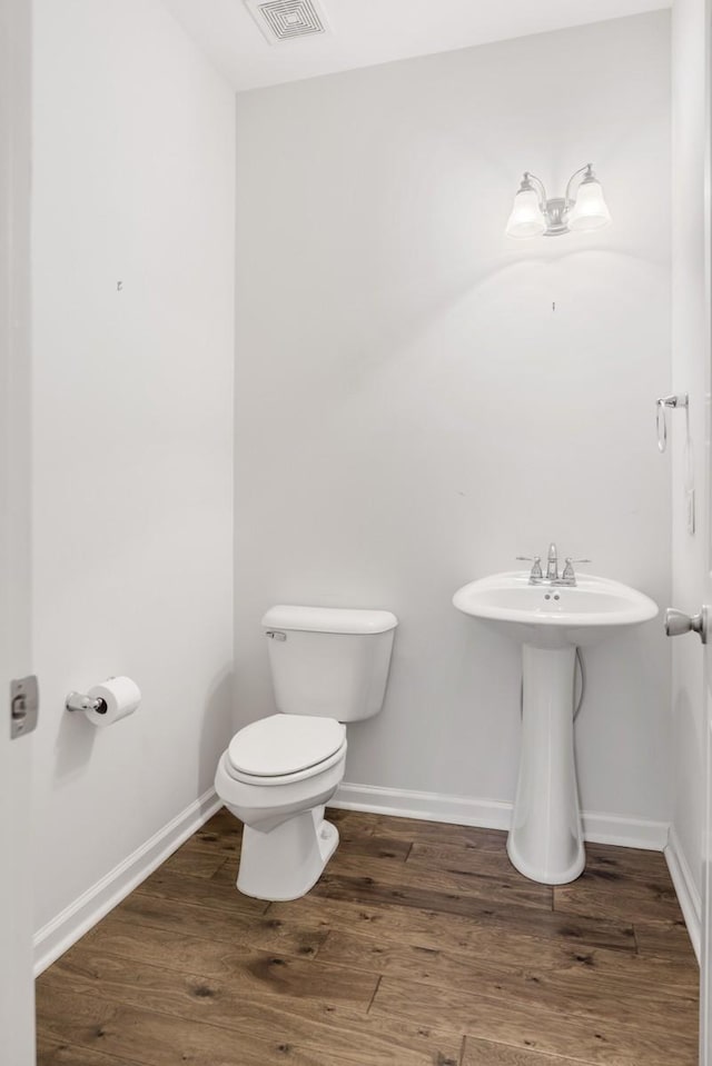 bathroom with sink, wood-type flooring, and toilet