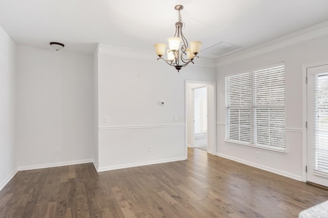 unfurnished room with crown molding, an inviting chandelier, and dark hardwood / wood-style flooring