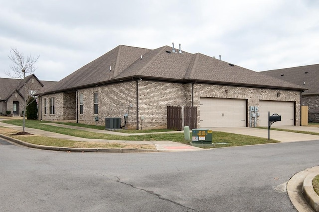 view of side of home featuring a garage and central AC unit