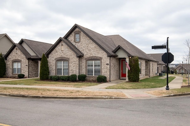 french country style house with a front lawn