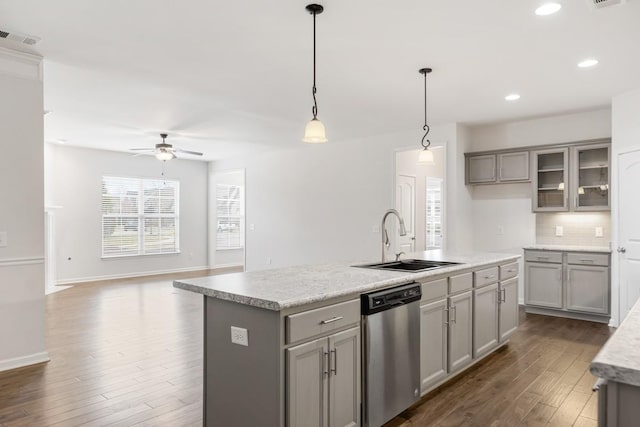 kitchen with pendant lighting, sink, gray cabinets, a kitchen island with sink, and stainless steel dishwasher