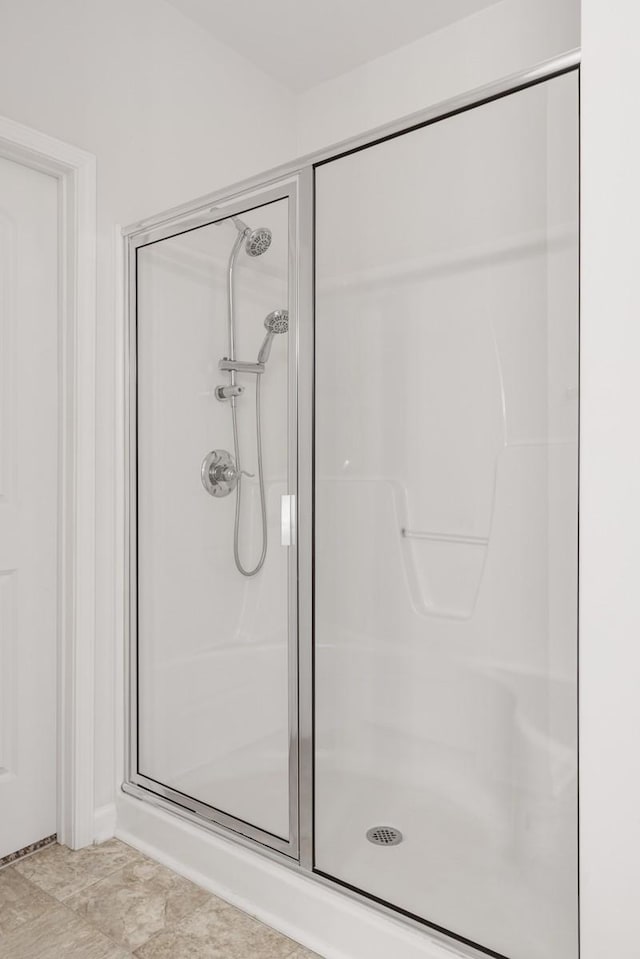 bathroom with a shower with shower door