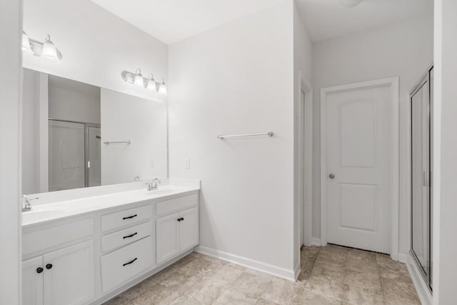 bathroom featuring walk in shower and vanity