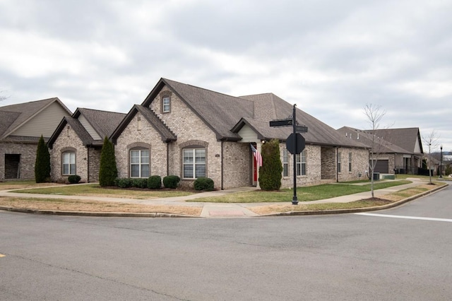 french country home with a front lawn