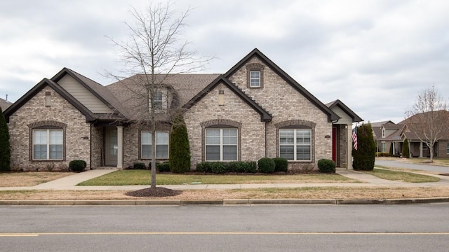 french country inspired facade featuring a front lawn