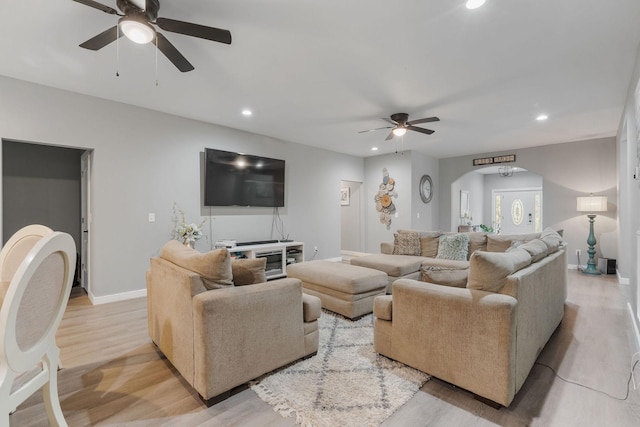 living room with ceiling fan and light wood-type flooring