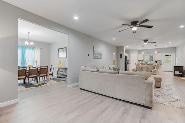 living room featuring an inviting chandelier and light wood-type flooring