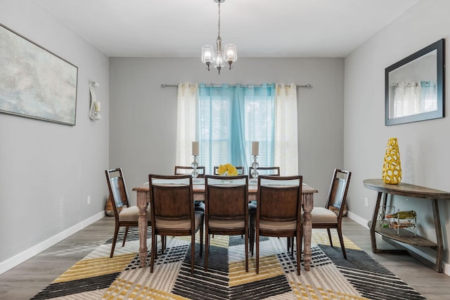 dining space featuring a notable chandelier and dark hardwood / wood-style floors