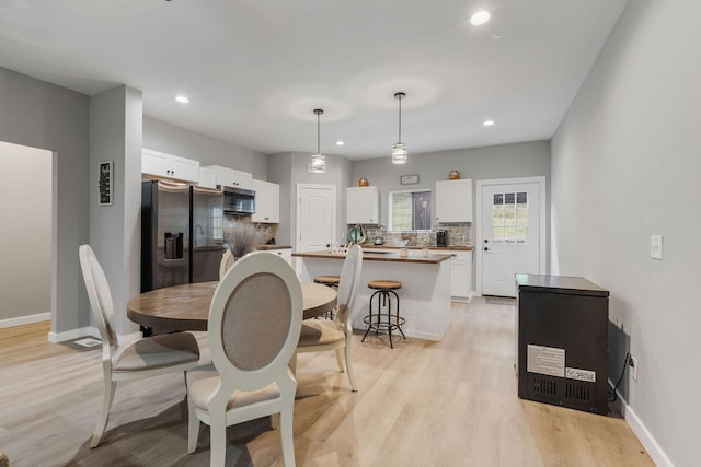 dining space featuring light wood-type flooring