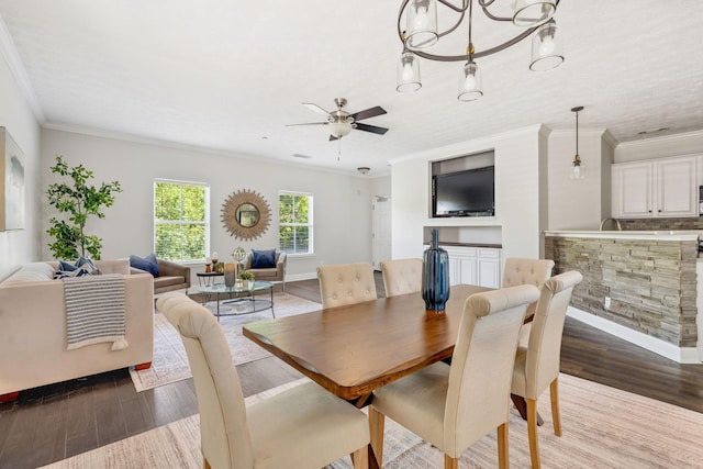 dining area with ornamental molding, light hardwood / wood-style floors, and ceiling fan