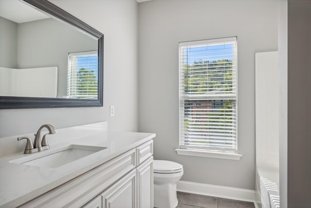 bathroom featuring vanity, tile patterned floors, and toilet