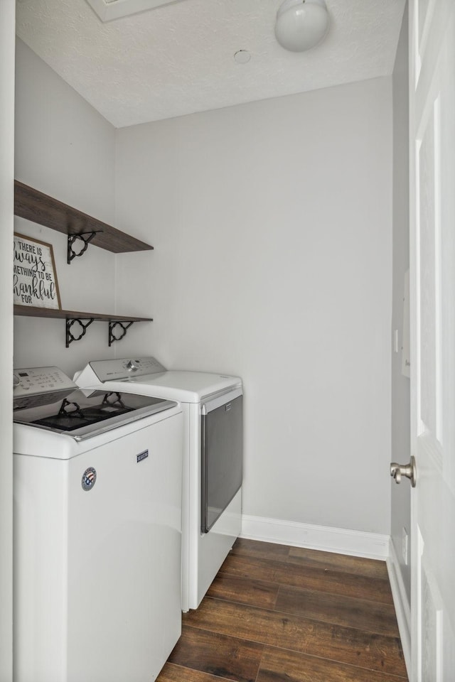 washroom featuring dark wood-type flooring and washer and dryer