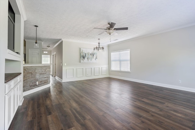 unfurnished living room with crown molding, dark hardwood / wood-style flooring, and ceiling fan with notable chandelier