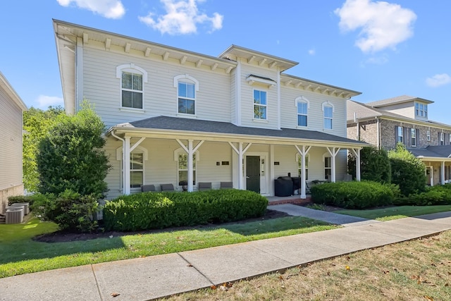 italianate-style house featuring central AC unit and covered porch