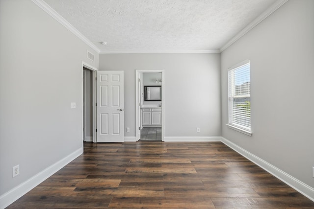 spare room with crown molding, a textured ceiling, and dark hardwood / wood-style flooring