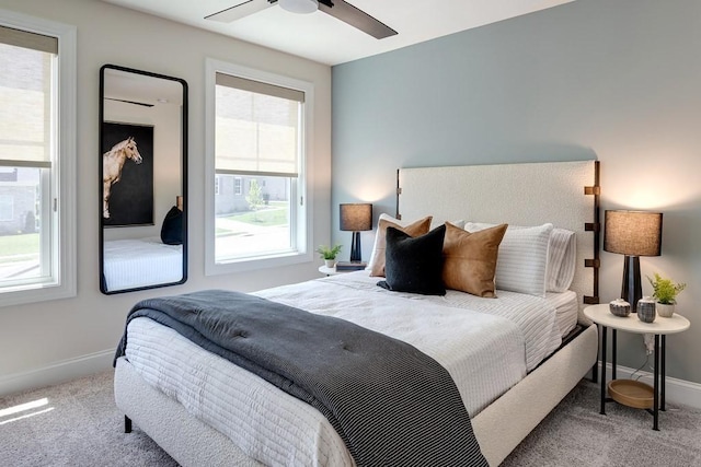 bedroom with light carpet and ceiling fan