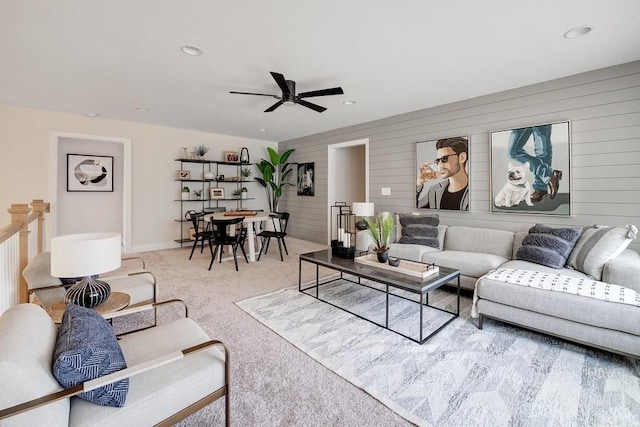 carpeted living room featuring ceiling fan