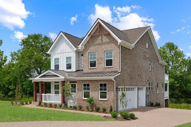 craftsman-style house with a garage, a front yard, and a porch