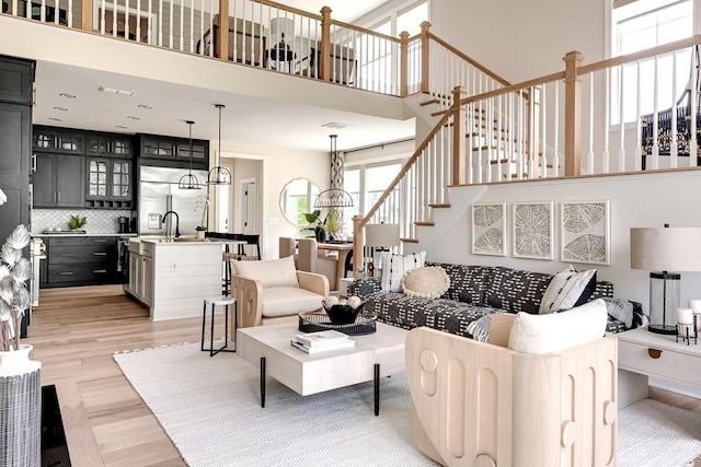 living room featuring light hardwood / wood-style flooring and a high ceiling