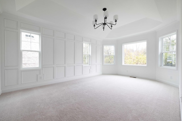 unfurnished sunroom with a raised ceiling and an inviting chandelier