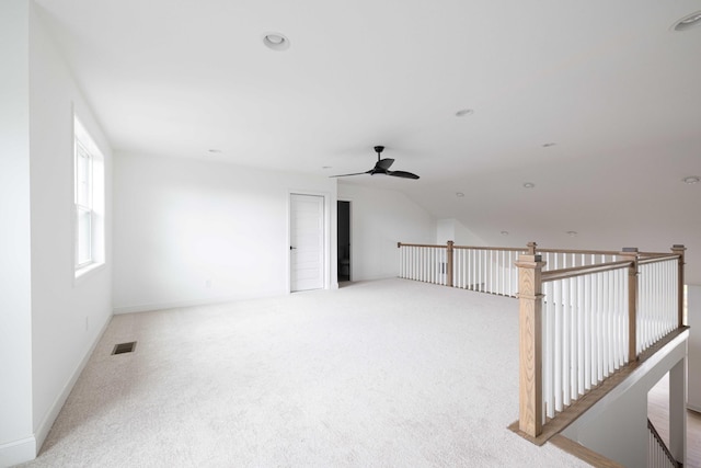 unfurnished room featuring ceiling fan, lofted ceiling, and light carpet