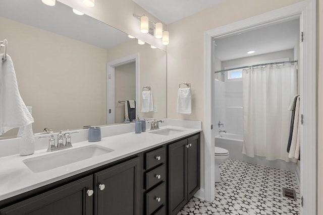 full bathroom featuring shower / bath combination with curtain, vanity, and toilet