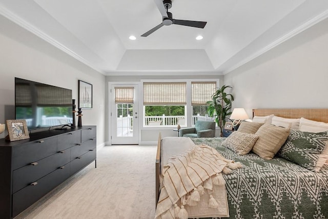 bedroom with access to exterior, ceiling fan, and a tray ceiling