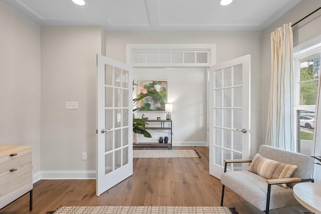 sitting room with light wood-type flooring and french doors