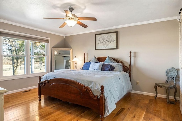 bedroom with crown molding, ceiling fan, and light hardwood / wood-style flooring