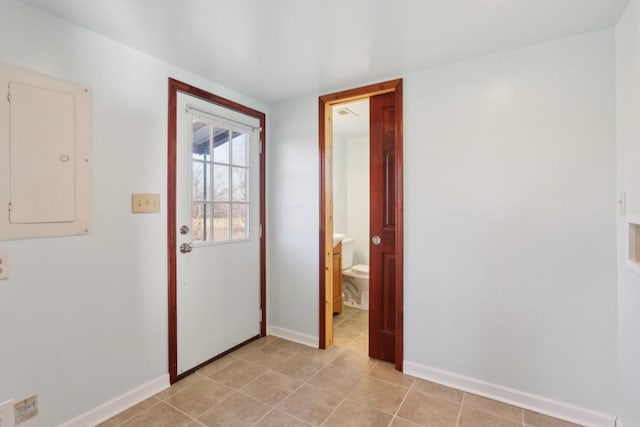 doorway to outside with electric panel and light tile patterned floors