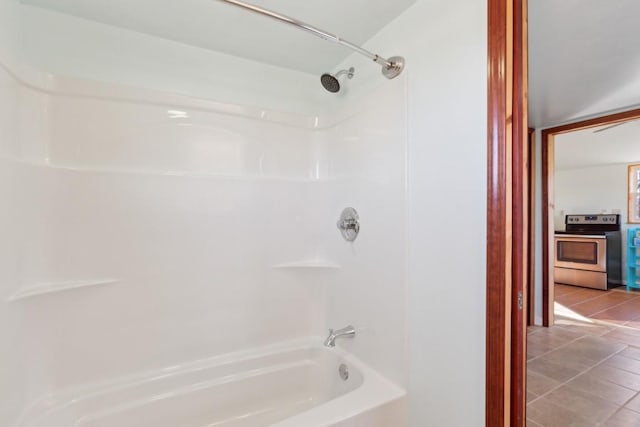 bathroom with tile patterned flooring and tub / shower combination