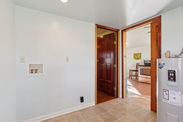 laundry area featuring light tile patterned flooring, electric water heater, and washer hookup