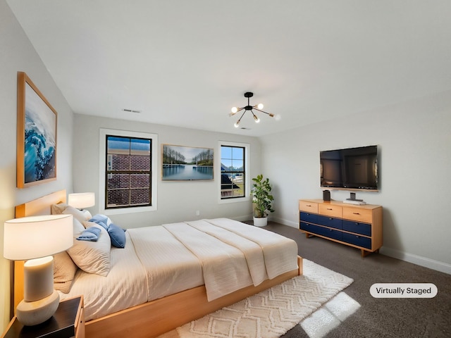 carpeted bedroom with a notable chandelier